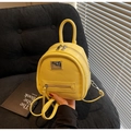 Detail of bright yellow mini backpack with silver zipper and smooth faux leather finish - Yellow