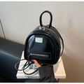 Macro detail of black patent leather mini backpack with silver metal plate and zipper - Black
