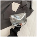 Detail of silver metallic handbag with fashion logo and balloon dog charm on grey suit - Silver