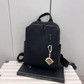 Minimalist black nylon travel backpack for women with multiple zipper pockets and M-charm - Black