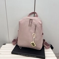 Minimalist dusty pink nylon backpack for college women featuring a stylish 'B' charm - Pink