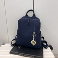 Minimalist navy blue nylon backpack for women with a letter M pendant and zipper details - Dark Blue
