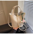 Detail of cream leather bucket bag with metal lock and horse charm decoration - With Pendant / Off White