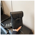 Detail of black faux leather phone bag with textured finish and retro horn toggle buckle - Black