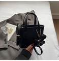 Detail of black mini bucket bag with rabbit embossing, dog charm and adjustable strap - With Charm / Black