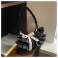 Detail of black satin underarm bag with soft ruffled edges and pink ribbon bow - Black