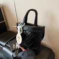 Black quilted bucket bag with wide strap and cartoon capybara charm detail - Black (With Charm)