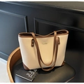 Beige lychee texture tote bag with brown trim and shoulder straps on leather chair - Off-white