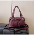 Large burgundy tote bag with drawstring pocket and adjustable shoulder strap on black bench - Red