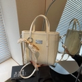 Cream-white woven bucket bag with lace bow charm and adjustable crossbody strap - Cream White With Pendant