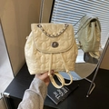 Creamy white star-quilted mini backpack with metal chain handle and twist lock closure - Yellow
