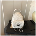 Chic beige quilted mini backpack featuring a silver twist lock and chain shoulder straps - White
