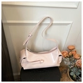 Close-up of pink glossy underarm bag showing smooth faux leather texture and side pockets - Pink