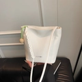 White bucket bag in pebble grain faux leather featuring a woven strap and wooden beads - Off White