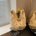 Chic cream white woven shoulder bag with floral cutout design and hobo style - Off White