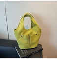 Detail of green canvas tote bag with dual front pockets and durable integrated handles - Green