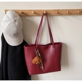 Detail view of burgundy tote bag hanging on wooden rack with cute teddy bear charm - Wine Red (With Charm)