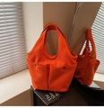 Vibrant orange canvas tote bag featuring double front pockets and round top handles - Orange