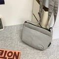 Minimalist grey casual nylon crossbody bag with adjustable strap and side brand label - Gray