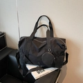 Large black nylon travel bag with adjustable strap and small round coin purse charm - Black