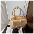 Chic beige textured handbag with lace trim and blue checkered bow accessory - Yellow