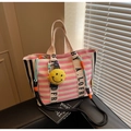 Pink and white striped canvas tote bag with a yellow smiley face charm and branded straps - Pink