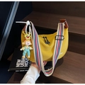 Yellow half-moon crossbody bag with striped shoulder strap and cartoon charm - Yellow with Pendant