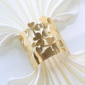 Detailed view of hollow four-leaf clover napkin ring with golden metallic finish - Reflective Gold