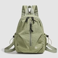 Detailed front view of green casual backpack with vertical zipper and side drawstrings - Green