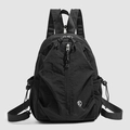 Front view of black nylon backpack featuring multiple pockets and white circular logo - Black