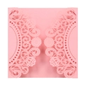 Close-up of pink laser-cut lace floral pattern on a formal invitation card sleeve - Pink
