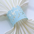 Detailed view of laser-cut light blue paper napkin ring with hollow heart pattern - Pearl Pale Blue