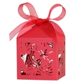 Detail view of red hollow laser-cut hibiscus candy box with matching sheer ribbon bow - Pearlescent Red