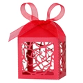 Close-up of laser-cut rose patterns on a red wedding favor box with a satin ribbon bow - Pearlescent Red