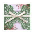 Macro detail of laser-cut green glitter wedding invitation with satin bow and floral insert - Dark Green Glitter Laser Cut Set
