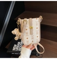 Detail of a creamy white cartoon bear crossbody bag with golden hardware and bear charm - White with Pendant