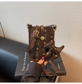 Close-up of a vintage brown crossbody phone bag with bear print on a black sofa - Coffee with Pendant
