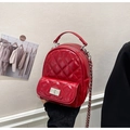 Red quilted mini backpack featuring glossy rhombic texture and silver chain strap - Red