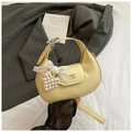 Detail of light yellow crescent bag with pleated texture and pearl heart pendant charm - Yellow