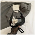 Detail of black patent leather crescent bag with pearl heart charm and lace ribbon - Black