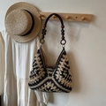 Woven hobo bag with black and beige geometric patterns and brown wooden bead strap - Black