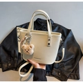 Chic cream-colored bucket bag with litchi texture leather and a cute bear charm - Off White