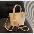 Chic beige lychee leather bucket bag with teddy bear pendant and striped ribbon - Khaki