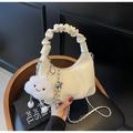 Detail view of off-white dumpling bag with scrunchie handle, chain strap and cloud charm - With Charm / Off White