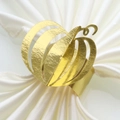 Macro detail of a golden pumpkin napkin ring with an elegant hollowed-out metal design - Mirror Gold