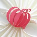 Close-up of laser-cut red pumpkin paper napkin rings for Halloween table decor - Pearlescent Red