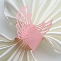 Pink pearlescent paper napkin rings featuring laser-cut angel wing design for weddings - Pink