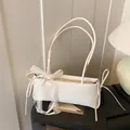 White minimalist shoulder bag with delicate lace bow and drawstring side details - White