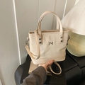 Elegant cream white canvas and leather bucket bag with silver logo and adjustable strap - Khaki