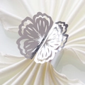 Close-up of a hollowed flower napkin ring with a polished silver finish and metal base - 20cm / Mirror Silver